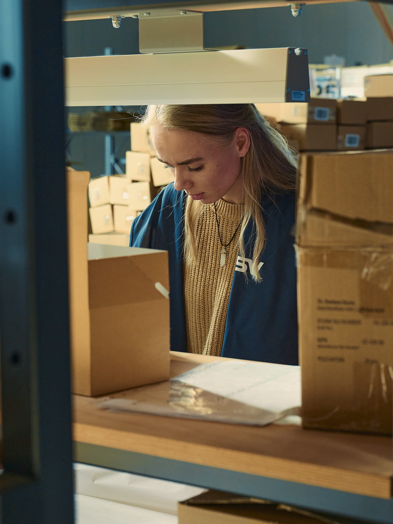 Young male trainee writing notes in a conference room